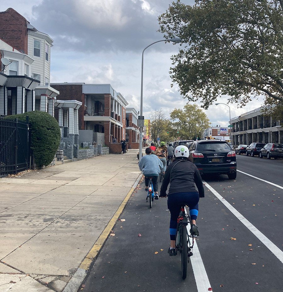 bicyclists in a parking-separated bike lane in West Philadelphia Credit DVRPC