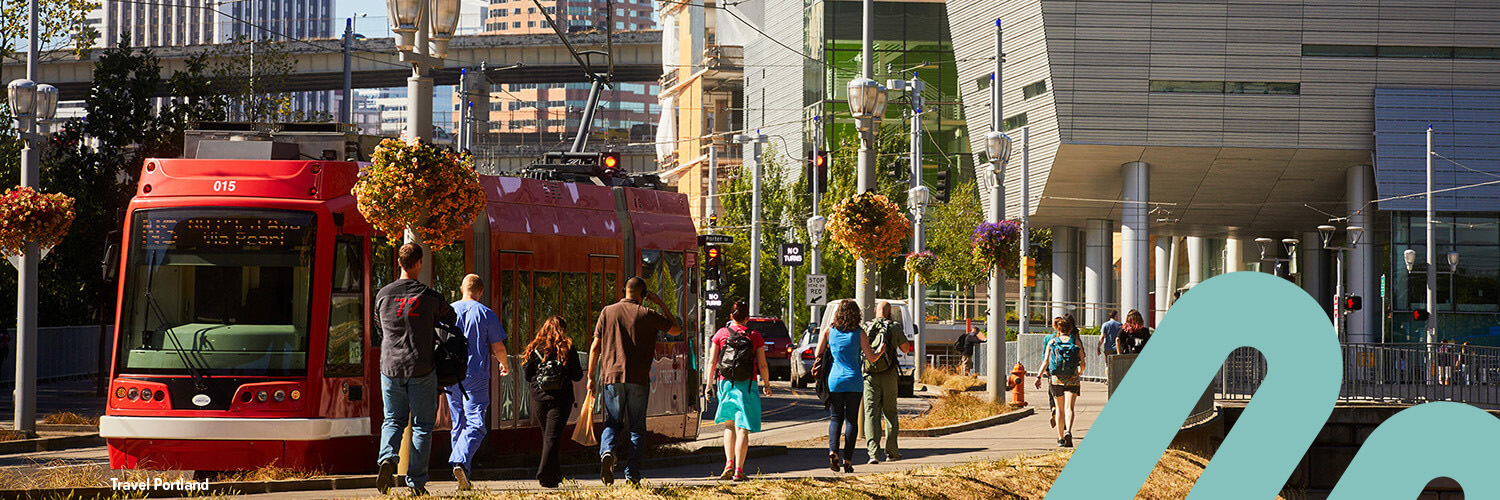 A streetcar and a group of people at South Waterfront in Portland.